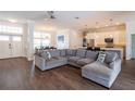 Spacious living room features a large sectional sofa, wood floors, and seamless open-concept design at 3027 Key Harbor Dr, Safety Harbor, FL 34695
