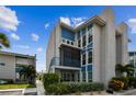 Bright exterior of a three-story condo building with large windows and blue trim at 315 Medallion Blvd # E, Madeira Beach, FL 33708