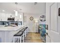 Modern kitchen with a breakfast bar, white cabinets, and stainless steel appliances at 315 Medallion Blvd # E, Madeira Beach, FL 33708