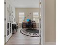 Stylish office with a unique keyboard rug, desk, and a piano at 4839 Pointe O Woods Dr, Wesley Chapel, FL 33543