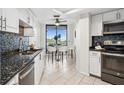Modern kitchen featuring stainless steel appliances, granite countertops, and a breakfast nook with stunning city views at 5950 Pelican Bay S Plz # 603, Gulfport, FL 33707