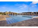 Resort-style pool area with cabanas, sun loungers, and a clear blue swimming pool for relaxation and enjoyment at 5950 Pelican Bay S Plz # 603, Gulfport, FL 33707