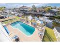 Beautiful backyard pool area with brick pavers, outdoor seating, and waterfront views at 6311 Bayside Dr, New Port Richey, FL 34652