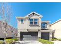 A charming townhome features a neutral exterior, a two-car garage, and well-maintained landscaping at 6827 Citrus Creek Ln, Tampa, FL 33625