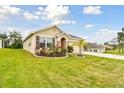 Beautiful single-story home with manicured lawn, desert landscaping, and a two-car garage on a large lot at 6882 Silverado Ranch Blvd, Zephyrhills, FL 33541