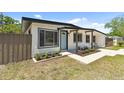 Charming single-story home with a well-manicured front yard and a welcoming covered porch at 7520 Orpine N Dr, St Petersburg, FL 33702