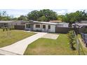 Beautifully landscaped front yard featuring a well-maintained lawn and attractive fencing at 7520 Orpine N Dr, St Petersburg, FL 33702