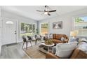 Inviting living room with neutral tones and lots of natural light showcasing the open and airy floor plan at 7520 Orpine N Dr, St Petersburg, FL 33702