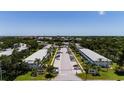 Aerial view of neighborhood street with mature trees and manicured landscaping on a sunny day at 8555 112Th St # 209, Seminole, FL 33772
