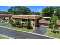 Two-story condo featuring a tile roof, screened-in patio, and attached garage at 10216 Seminole Island Dr, Largo, FL 33773