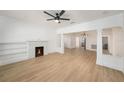 Bright living room with a decorative fireplace, built-in shelving, and light wood floors at 104 W South Ave, Tampa, FL 33603