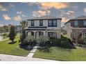 Charming two-story home with a well-manicured lawn and inviting front entrance at 12421 Triple Creek Blvd, Riverview, FL 33579