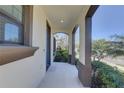 Inviting covered front porch with elegant columns and manicured landscaping at 12421 Triple Creek Blvd, Riverview, FL 33579