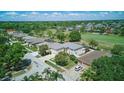 An aerial view features a suburban home next to a golf course and meticulously kept landscaping in the community at 13122 Prestwick Dr, Riverview, FL 33579
