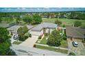 An aerial view shows a well-maintained home with a lush green lawn and beautiful mature trees in the neighborhood at 13122 Prestwick Dr, Riverview, FL 33579
