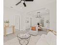 Bright living room with luxury vinyl floors, recessed lights, ceiling fan and an opening to the dining room at 1314 E Louise Ave, Tampa, FL 33603
