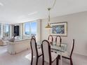 Bright dining room with glass table set and view of the ocean at 1430 Gulf Blvd # 309, Clearwater Beach, FL 33767