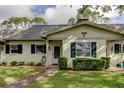 Attractive home exterior with a well-kept lawn, symmetrical landscaping, and dark shutters complementing the neutral paint at 1466 Normandy Park Dr # 4, Clearwater, FL 33756