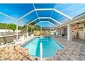 Screened-in swimming pool area with beautiful tile and stone accents at 151 Harrisburg St, Port Charlotte, FL 33954