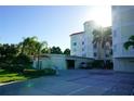 Exterior view of parking garage and entrance to condominium building with sun glare enhancing the architectural details at 1860 N Fort Harrison Ave # 301, Clearwater, FL 33755