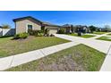 A well-kept home with a manicured lawn and mature landscaping at 18715 Alfaro Loop Ct, Spring Hill, FL 34610
