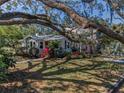 Charming home with mature landscaping, shade trees, and well-kept lawn at 223 Lime S Cir, Dunedin, FL 34698