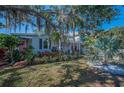 Charming home with mature landscaping and a well-kept lawn in a quiet neighborhood at 223 Lime S Cir, Dunedin, FL 34698