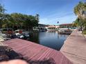 Scenic view of a waterfront condo community with private boat docks and lush tropical landscaping at 2571 Cyprus Dr # 1-102, Palm Harbor, FL 34684