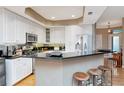 Spacious kitchen with granite countertops, breakfast bar, white cabinets, and stainless appliances at 2837 Bayshore Trails Dr, Tampa, FL 33611