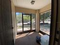 View of the sunroom that has an outdoor view through the glass windows and door at 3257 Bluestone Ave, Spring Hill, FL 34609