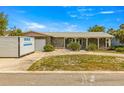 Charming single-story home featuring stone accents, a covered porch and well-maintained landscaping at 4061 13Th Ne Ln, St Petersburg, FL 33703