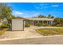 Charming single-story home featuring stone accents, a covered porch and well-maintained landscaping at 4061 13Th Ne Ln, St Petersburg, FL 33703