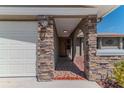 Inviting home entrance features decorative brickwork, stone accents, and tiled walkway at 4109 Rudder Way, New Port Richey, FL 34652