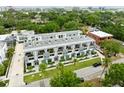 Aerial view of townhomes with balconies, landscaping, and nearby city skyline in the background at 4515 W North A St # 4, Tampa, FL 33609