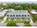 Aerial view of modern townhomes showcasing balconies, landscaping, and urban location surrounded by trees at 4515 W North A St # 4, Tampa, FL 33609