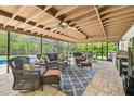 Relaxing outdoor screened patio featuring comfortable seating, ceiling fans, and views of lush greenery at 4555 Debbie Ln, Lutz, FL 33559