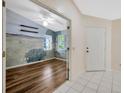 Bright living room with hardwood floors and a unique mural wall that adds character to the space at 5245 Lochmead Ter, Zephyrhills, FL 33541