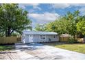 Inviting single-story home features a new driveway, metal roof, and manicured landscaping, enhancing its appeal at 5444 70Th N Ln, St Petersburg, FL 33709