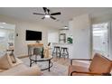 Inviting living space with hardwood floors, a ceiling fan, and a seamless flow into the modern kitchen at 5444 70Th N Ln, St Petersburg, FL 33709