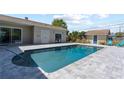 Backyard pool with a large deck, easy access to the main house, and a pool house at 715 39Th Ne Ave, St Petersburg, FL 33703