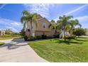 Exterior of a well-kept home boasting beautiful landscaping and lush green grass at 7345 Brightwaters Ct, New Port Richey, FL 34652