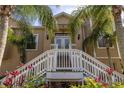 Home exterior featuring a grand staircase leading to a welcoming covered front entrance at 7345 Brightwaters Ct, New Port Richey, FL 34652