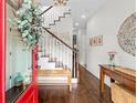 Welcoming foyer with hardwood floors, staircase, and decorative accents at 7417 S Morton St, Tampa, FL 33616