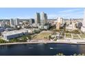 Aerial view of downtown with modern buildings, a park and water view under a blue sky at 777 N Ashley Dr # 2610, Tampa, FL 33602