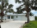 Charming single-story home with a paved driveway, well-kept lawn, and inviting curb appeal and a light blue trim at 7912 Causeway S Blvd, St Petersburg, FL 33707