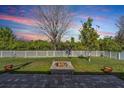 Serene backyard with a brick-paved patio and a cozy fire pit for outdoor gatherings at 8247 Westhaven Dr, Land O Lakes, FL 34638