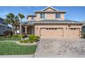 Charming two-story home with a three-car garage and neatly landscaped front yard at 8247 Westhaven Dr, Land O Lakes, FL 34638