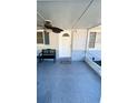 Covered front porch with bench seating and a ceiling fan for comfort at 8766 91St St, Seminole, FL 33777
