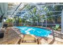 Inviting screened pool area with brick pavers and comfortable lounging furniture at 8766 91St St, Seminole, FL 33777