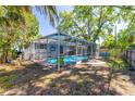 A screened-in pool area offers a private and refreshing outdoor space with lush greenery around at 8766 91St St, Seminole, FL 33777